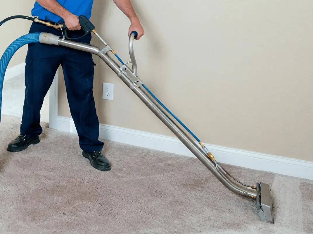Professional operating a liquid removal machine on a carpeted floor in Boulder, CO